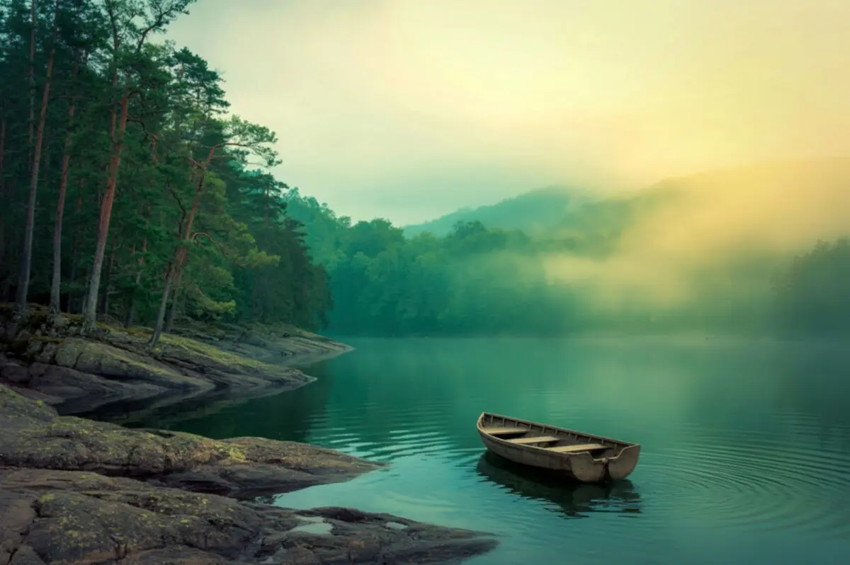 Smooth rock at the edge of a still mountain lake