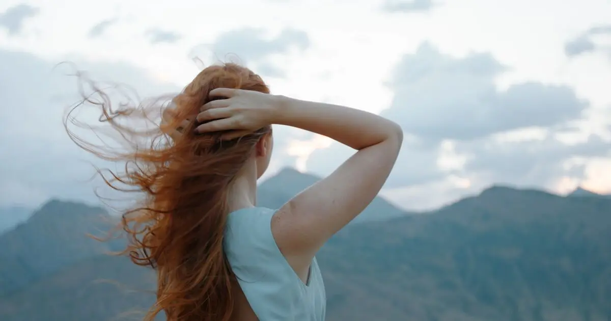 A woman with her hair moving in the wind