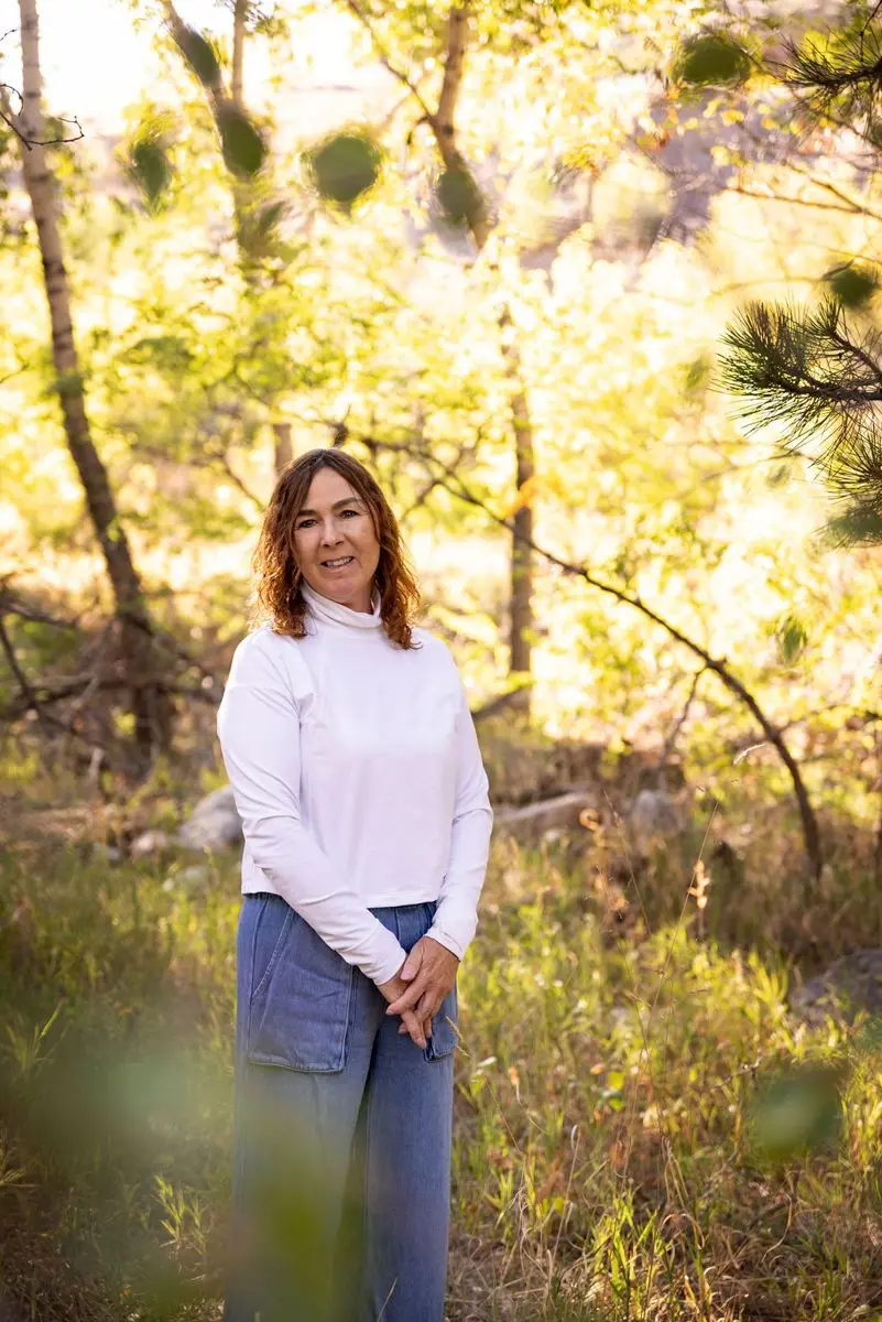 Melissa Hunt standing among aspen trees